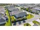 Real estate aerial showcasing a home with lawn, privacy wall, and landscaping in a neighborhood setting at 1853 Pasqua Pl, The Villages, FL 32163
