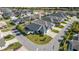 This aerial view showcases a neighborhood with well-maintained homes and lush landscaping at 1853 Pasqua Pl, The Villages, FL 32163