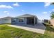 Lush backyard featuring a screened lanai, storage shed, and a block wall at 1853 Pasqua Pl, The Villages, FL 32163