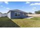 Well-manicured backyard with block wall, lush grass, and privacy fence at 1853 Pasqua Pl, The Villages, FL 32163