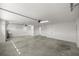 Spacious garage with ample lighting and smooth concrete flooring, perfect for parking and storage at 1853 Pasqua Pl, The Villages, FL 32163