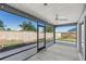 Screened-in lanai overlooking a fenced yard with block wall and mature trees at 1853 Pasqua Pl, The Villages, FL 32163