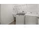 Convenient laundry room with a utility sink and modern washer and dryer set for easy laundry care at 1853 Pasqua Pl, The Villages, FL 32163