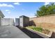 Backyard featuring a storage shed, garden, and block wall for privacy at 1853 Pasqua Pl, The Villages, FL 32163