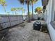 A fenced backyard shows a brick patio with air conditioning units and palm trees at 1928 Conway Rd # 23, Orlando, FL 32812