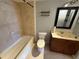 Bathroom featuring a vanity with dark wood cabinets, a black framed mirror, and a tiled shower/tub combination at 1928 Conway Rd # 23, Orlando, FL 32812