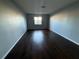 Empty bedroom with hardwood floors and natural light from a window at 1928 Conway Rd # 23, Orlando, FL 32812