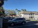 Apartment building exterior with parking lot, landscaping, and visible building number at 1928 Conway Rd # 23, Orlando, FL 32812