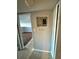Hallway featuring tile flooring and access to living space with updated flooring and a gray painted electrical panel at 1928 Conway Rd # 23, Orlando, FL 32812