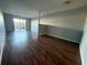Open living space with hardwood floors, grey walls, and access to a private patio at 1928 Conway Rd # 23, Orlando, FL 32812