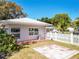 Inviting backyard showcasing a cozy patio area, complemented by lush greenery and a classic white picket fence at 193 Bay Rd, Mount Dora, FL 32757