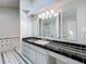 Bathroom with black-tiled countertop, double vanity and enclosed shower at 193 Bay Rd, Mount Dora, FL 32757