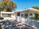 Charming single-story home featuring a white picket fence, well-maintained lawn, and a detached garage at 193 Bay Rd, Mount Dora, FL 32757