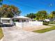 Inviting one-story home with a charming white picket fence, brick entryway, and mature landscaping at 193 Bay Rd, Mount Dora, FL 32757