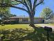 Charming single-story home with a well-maintained lawn and mature tree providing shade at 2181 Gretna Dr, Deltona, FL 32738