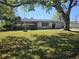 Lovely one-story home featuring a green lawn, beautiful shrubbery, and a two-car garage at 2181 Gretna Dr, Deltona, FL 32738