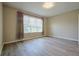 Bright empty bedroom with a large window and vinyl flooring, ready for personalization and decor at 2183 Ridge Pointe Ln, Clermont, FL 34715