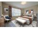 This is a bedroom with a large window, patterned curtains, a light gray accent rug, and a white leather bed at 2183 Ridge Pointe Ln, Clermont, FL 34715