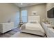 This is a bedroom with a white upholstered bed, a side table, a dresser, and light gray wood floors at 2183 Ridge Pointe Ln, Clermont, FL 34715
