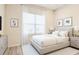 This is a bright bedroom with a large window, white curtains, a gray upholstered bed, and a light gray rug at 2183 Ridge Pointe Ln, Clermont, FL 34715