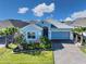 Charming single-story home with a brick driveway, manicured lawn and tropical landscaping at 2183 Ridge Pointe Ln, Clermont, FL 34715