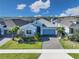 Charming single-Gathering home with a brick driveway, manicured lawn, and lush tropical landscaping at 2183 Ridge Pointe Ln, Clermont, FL 34715