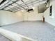 Spacious two car garage with gray epoxy flooring and overhead rack storage at 2183 Ridge Pointe Ln, Clermont, FL 34715