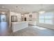 Bright, spacious kitchen featuring white cabinetry, stainless appliances, and stylish pendant lighting at 2183 Ridge Pointe Ln, Clermont, FL 34715