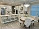 Elegant eat-in kitchen boasts a large island, pendant lighting, stainless steel appliances, and a separate dining area at 2183 Ridge Pointe Ln, Clermont, FL 34715