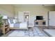Comfortable main bedroom features a king bed, stylish decor, and an en-suite bathroom for added convenience at 2183 Ridge Pointe Ln, Clermont, FL 34715