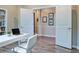 Bright home office with a white desk, built-in bookcase, and wood-look tile flooring at 2183 Ridge Pointe Ln, Clermont, FL 34715
