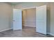Neutral office space with wood-look floors, base molding, and double doors leading to the hallway at 2183 Ridge Pointe Ln, Clermont, FL 34715