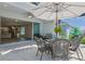The covered patio features a dining table with chairs, outdoor decorations, and sliding glass doors at 2183 Ridge Pointe Ln, Clermont, FL 34715