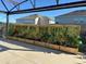 Back patio with wooden planter boxes with growing vines providing a lovely outdoor space at 2183 Ridge Pointe Ln, Clermont, FL 34715