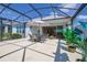 Enjoy outdoor dining on this screened in patio with an umbrella, table and chairs at 2183 Ridge Pointe Ln, Clermont, FL 34715