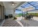 The covered patio features a dining table with chairs, outdoor decorations, and a ceiling fan at 2183 Ridge Pointe Ln, Clermont, FL 34715