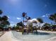 Community splash pad featuring a bucket water dump and seating for Gathering fun on sunny days at 2183 Ridge Pointe Ln, Clermont, FL 34715