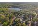 Beautiful aerial view of homes nestled among mature trees near a picturesque lake with abundant vegetation at 219 N Rossiter St, Mount Dora, FL 32757