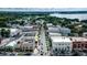 Aerial view of a town with tree-lined streets, showcasing a blend of residential and commercial properties at 219 N Rossiter St, Mount Dora, FL 32757