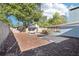 Large backyard featuring a stone paver patio, a picnic table, and a well-maintained wooden privacy fence at 219 N Rossiter St, Mount Dora, FL 32757