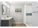 Stylish bathroom featuring a new sink, shower with decorative tile, and sleek wood floors at 219 N Rossiter St, Mount Dora, FL 32757