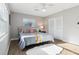 Well-lit bedroom features hardwood floors, ceiling fan and modern decor at 219 N Rossiter St, Mount Dora, FL 32757