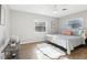 Bright bedroom with wood-look flooring, a ceiling fan, and a cozy rug at 219 N Rossiter St, Mount Dora, FL 32757
