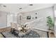 Bright dining room featuring a glass table, six chairs, modern lighting, and an area rug at 219 N Rossiter St, Mount Dora, FL 32757