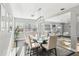 Open floorplan with bright dining room, hardwood floors, and connected living area at 219 N Rossiter St, Mount Dora, FL 32757