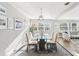 Bright dining room with glass table, seating for six, modern fixtures, and wood flooring at 219 N Rossiter St, Mount Dora, FL 32757