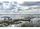 Picturesque waterfront view featuring a boat dock, boat rentals, and airplane in the sky at 219 N Rossiter St, Mount Dora, FL 32757