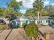 Inviting single-story home with well-maintained landscaping, a gravel yard, and a charming blue front door at 219 N Rossiter St, Mount Dora, FL 32757