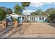 Charming single-story home featuring a well-manicured gravel yard and bright blue front door at 219 N Rossiter St, Mount Dora, FL 32757