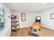 Bright game room with sleek wood floors, shelf with trinkets, and shuffleboard table at 219 N Rossiter St, Mount Dora, FL 32757
